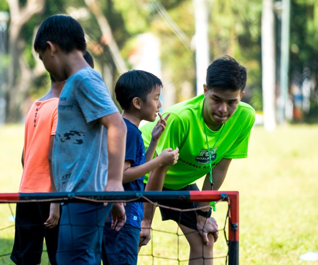 football coach listening to his student