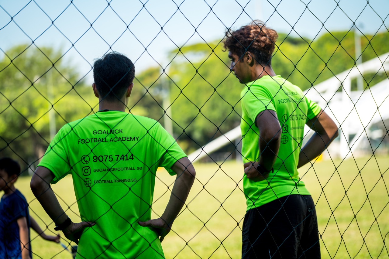 coaches overlooking the football field