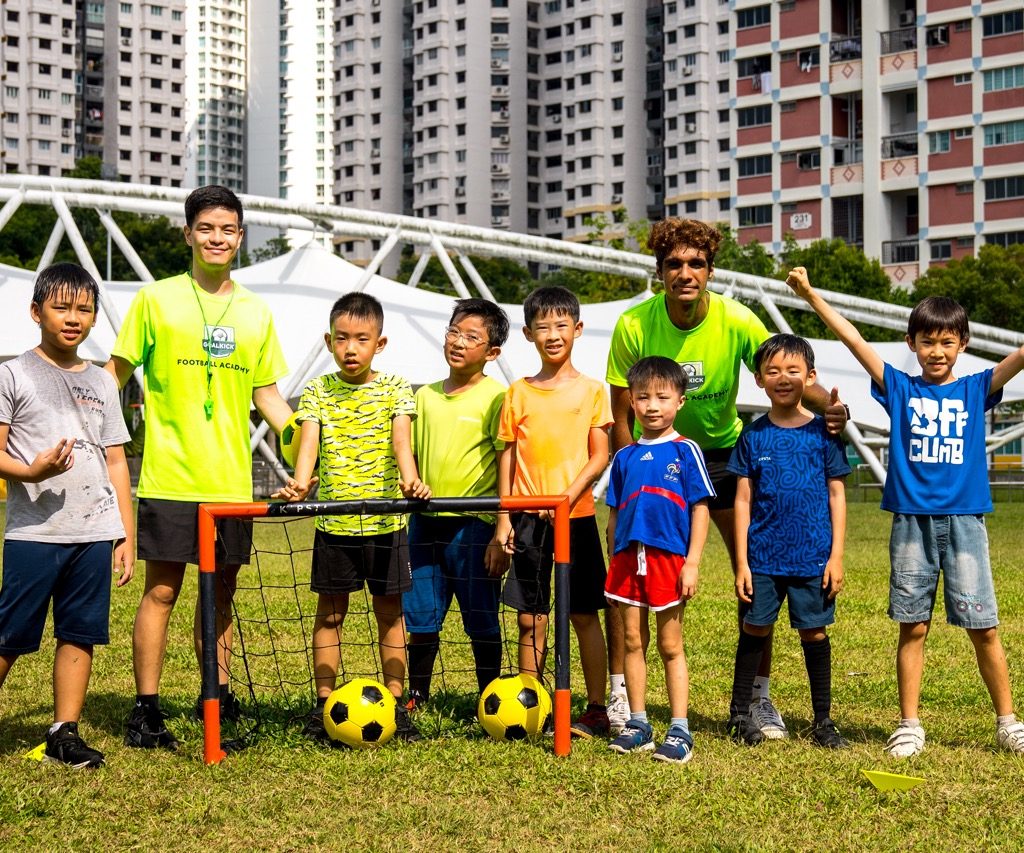 group photo of football coaches and students