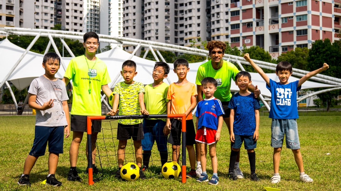 group photo of football coaches and students