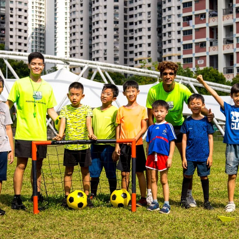 group photo of football coaches and students